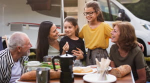 Family having a meal outside their motorhome